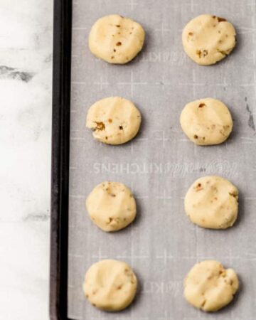 Overhead view of cookie dough on parchment lined sheet pan.